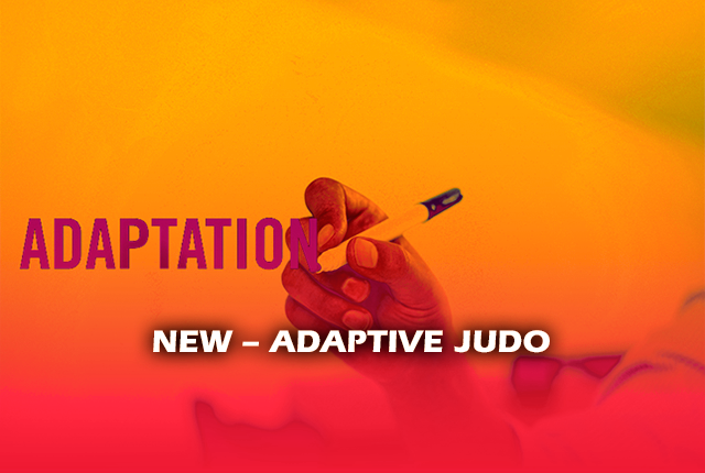 A person holding a pencil finishing to write the word adaptation. Written front of the image: New - adaptative judo